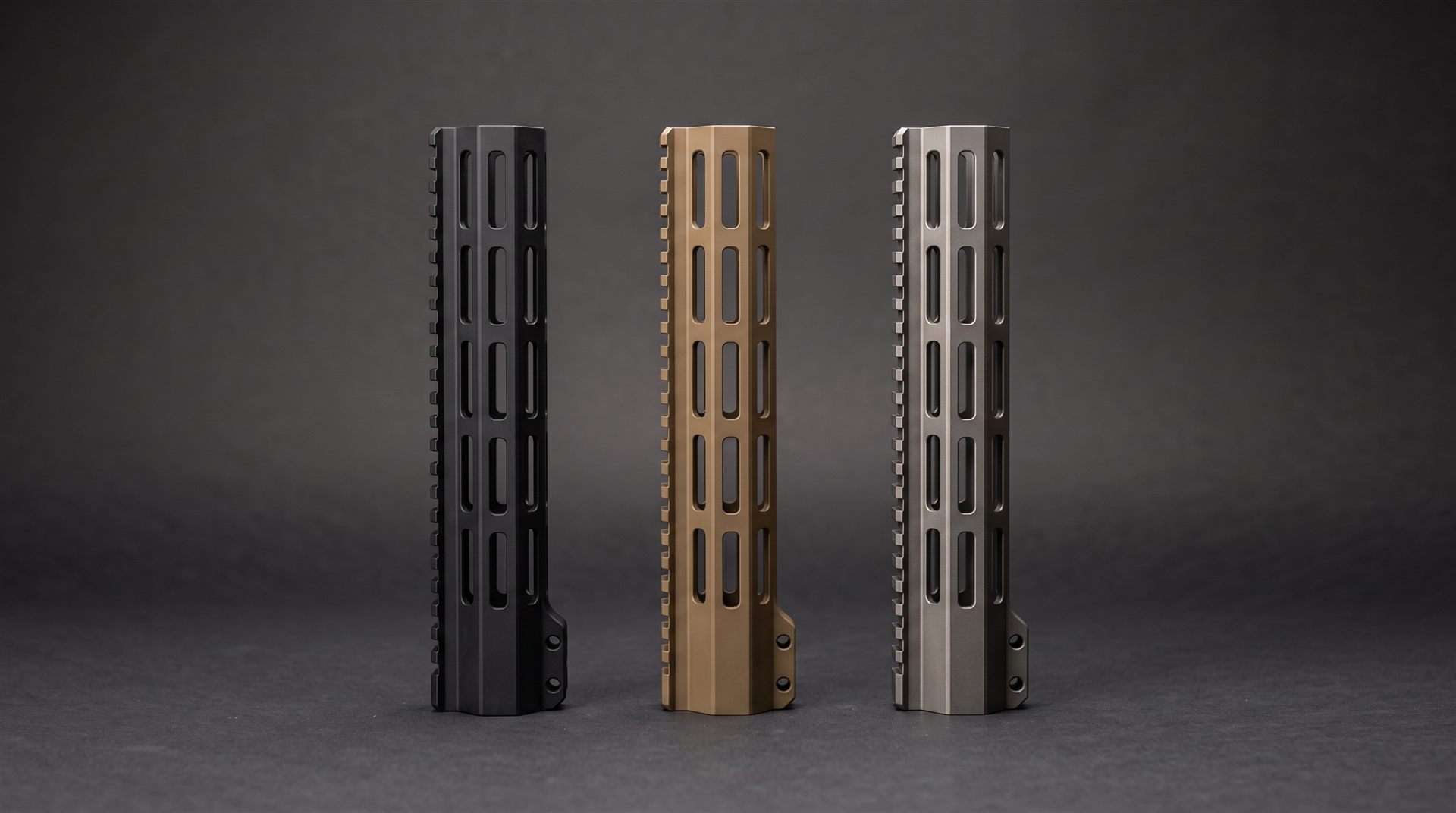 Three AR-15 handguards in matte black, flat dark earth, and tungsten grey Cerakote