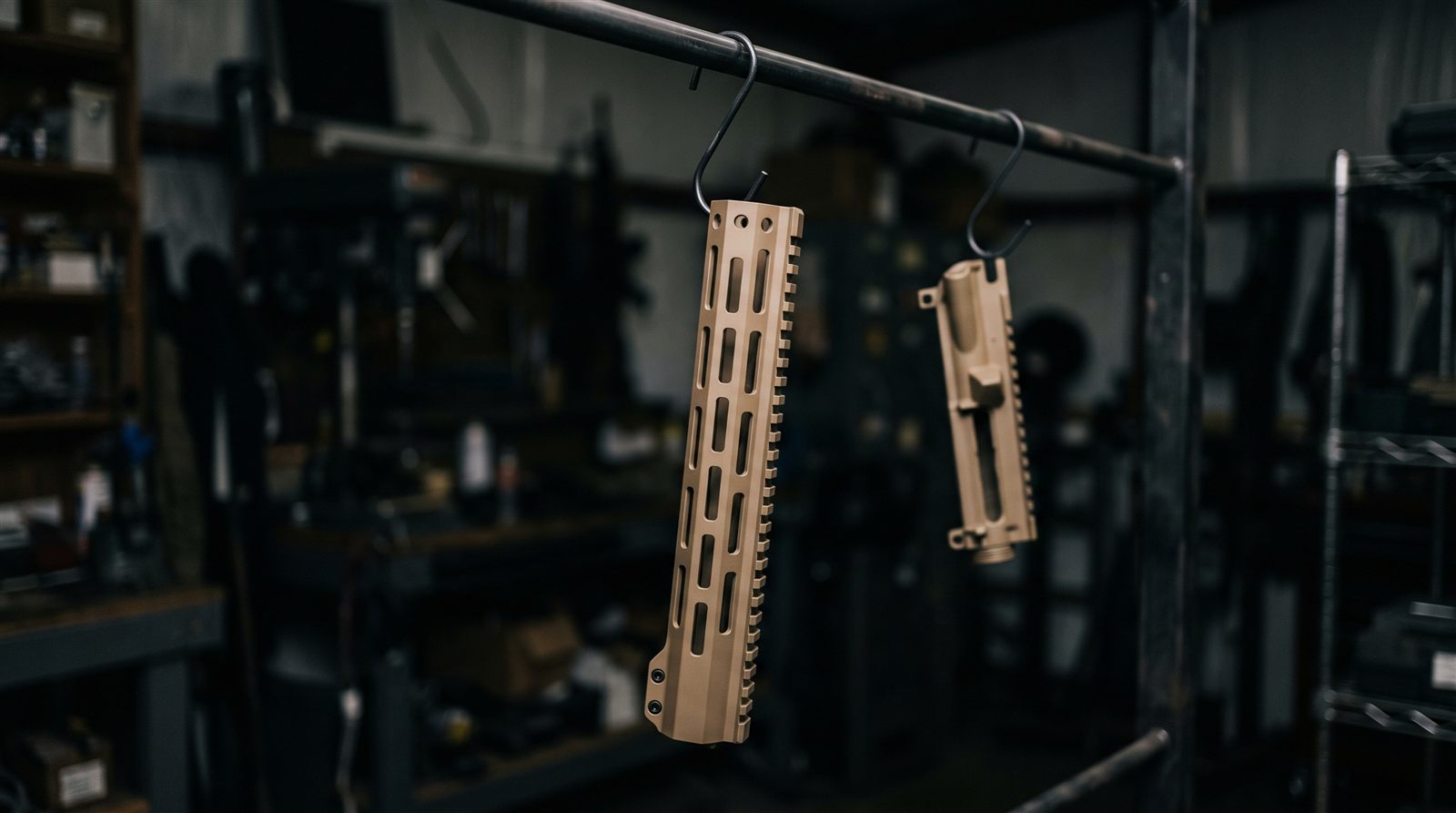 Freshly Cerakoted handguard hanging on a curing rack